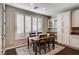 Breakfast nook with wood table and chairs, white cabinets, and window shutters at 8593 Garden Valley Ct, Las Vegas, NV 89178