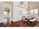 Elegant dining room features hardwood floors, a chandelier, and an arched entryway at 8593 Garden Valley Ct, Las Vegas, NV 89178