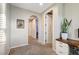 Upper hallway with an arched doorway and carpeted floors at 8593 Garden Valley Ct, Las Vegas, NV 89178