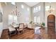 High ceiling living room with hardwood floors, dining area, and a chandelier at 8593 Garden Valley Ct, Las Vegas, NV 89178