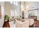 Living room with hardwood floors, high ceilings, and comfortable seating at 8593 Garden Valley Ct, Las Vegas, NV 89178