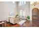 Living room with hardwood floors, high ceilings, and a neutral color scheme at 8593 Garden Valley Ct, Las Vegas, NV 89178