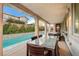 Covered patio with dining area and refreshing pool view at 8593 Garden Valley Ct, Las Vegas, NV 89178