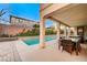 Covered patio with dining furniture and a view of the pool at 8593 Garden Valley Ct, Las Vegas, NV 89178