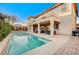 Expansive backyard with a large pool, patio, and seating area at 8593 Garden Valley Ct, Las Vegas, NV 89178