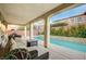 Relaxing covered patio with seating and a view of the pool at 8593 Garden Valley Ct, Las Vegas, NV 89178