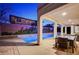 Luxury pool and patio area with dining table at 8593 Garden Valley Ct, Las Vegas, NV 89178