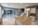 Open concept kitchen with marble floors and island at 8719 Mount Mira Loma Ave, Las Vegas, NV 89178