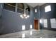 Two-story living room with marble floors and chandelier at 8719 Mount Mira Loma Ave, Las Vegas, NV 89178