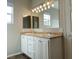 Double vanity bathroom with updated light fixtures and mirrors at 8777 W Maule Ave # 2109, Las Vegas, NV 89148