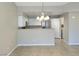 Eat-in kitchen with white cabinets and breakfast bar at 8777 W Maule Ave # 2109, Las Vegas, NV 89148