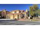 Two-story house with tan exterior, tile roof, and two-car garage at 8916 Stafford Springs Dr, Las Vegas, NV 89134