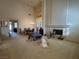 Spacious living room with high ceilings, fireplace, and dining area at 8916 Stafford Springs Dr, Las Vegas, NV 89134