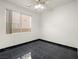 Simple bedroom with dark tile floors and a ceiling fan at 9523 Cherrydale Ct, Las Vegas, NV 89147