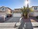 Two-story house with a white garage door and a palm tree in the front yard at 9523 Cherrydale Ct, Las Vegas, NV 89147