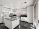 Kitchen with white cabinets, granite countertops and island at 9523 Cherrydale Ct, Las Vegas, NV 89147