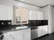 Kitchen with white cabinets, granite countertops, and a stainless steel dishwasher at 9523 Cherrydale Ct, Las Vegas, NV 89147