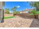 Spacious backyard with paved patio, artificial turf, and block wall at 10968 Fintry Hills St, Las Vegas, NV 89141