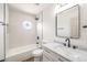 Clean bathroom with a bathtub, single vanity, and updated fixtures at 10968 Fintry Hills St, Las Vegas, NV 89141