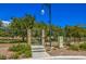 Gated community entrance with landscaping and security features at 10968 Fintry Hills St, Las Vegas, NV 89141