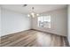 Bright dining room with hardwood floors and a modern chandelier at 10968 Fintry Hills St, Las Vegas, NV 89141