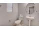 Small bathroom with pedestal sink and toilet at 1167 Vacation Valley Ave, Las Vegas, NV 89183