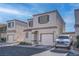 Two-story house with attached garage, and driveway parking at 1167 Vacation Valley Ave, Las Vegas, NV 89183