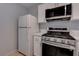 Modern kitchen with stainless steel appliances and white cabinets at 1167 Vacation Valley Ave, Las Vegas, NV 89183