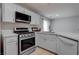 Modern kitchen with stainless steel appliances and white cabinets at 1167 Vacation Valley Ave, Las Vegas, NV 89183