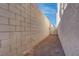 Long, narrow side yard with block wall and gravel at 1167 Vacation Valley Ave, Las Vegas, NV 89183