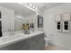 Double vanity bathroom with modern gray cabinets and a large mirror at 135 Harmonica Ave # Lot 18, Henderson, NV 89011