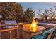 Outdoor kitchen with fire pit and hot tub at 138 Reflection Cove Dr, Henderson, NV 89011