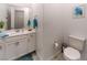 White vanity with toilet and teal accents at 138 Reflection Cove Dr, Henderson, NV 89011