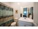 Bathroom featuring a decorative shower curtain, ample lighting, and an adjacent study room at 138 Reflection Cove Dr, Henderson, NV 89011