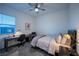 Cozy bedroom with neutral tones, a ceiling fan, a desk, and a comfortable bed at 138 Reflection Cove Dr, Henderson, NV 89011