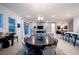 Open concept dining room with a round table and chairs, offering views into the living room and kitchen at 138 Reflection Cove Dr, Henderson, NV 89011