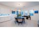 Bright dining room with a large round table, modern chandelier, and stylish decor at 138 Reflection Cove Dr, Henderson, NV 89011