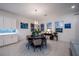 Elegant dining room with a round table and six chairs, featuring a modern chandelier at 138 Reflection Cove Dr, Henderson, NV 89011