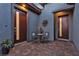 Courtyard entry with two doors and small seating area at 138 Reflection Cove Dr, Henderson, NV 89011