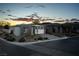 Single story home with stone facade at sunset at 138 Reflection Cove Dr, Henderson, NV 89011