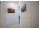 Hallway featuring modern wall art, neutral paint and leading to a sunlit room at 138 Reflection Cove Dr, Henderson, NV 89011