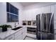 Kitchen featuring stainless steel appliances, granite countertops, and white cabinets at 138 Reflection Cove Dr, Henderson, NV 89011