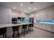 Modern kitchen with white cabinets, stainless steel appliances and a blue tile backsplash at 138 Reflection Cove Dr, Henderson, NV 89011