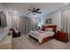 Relaxing primary bedroom with a ceiling fan, carpet, and a comfortable reading chair near the patio at 138 Reflection Cove Dr, Henderson, NV 89011