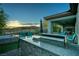 Granite outdoor kitchen with grill and fire pit at 138 Reflection Cove Dr, Henderson, NV 89011