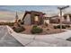 Street view of a corner-lot home featuring manicured landscaping, desert landscaping, and a two-car garage at 138 Reflection Cove Dr, Henderson, NV 89011