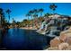 Resort-style pool and waterfall feature, surrounded by lush landscaping at 138 Reflection Cove Dr, Henderson, NV 89011