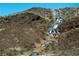 Stunning layered waterfall feature on a desert hillside at 138 Reflection Cove Dr, Henderson, NV 89011