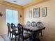 Formal dining room with elegant table, six chairs, and natural light at 1404 Crystal Rainey Ave, North Las Vegas, NV 89086