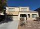 Two-story house with beige exterior, attached garage, and landscaping at 1404 Crystal Rainey Ave, North Las Vegas, NV 89086